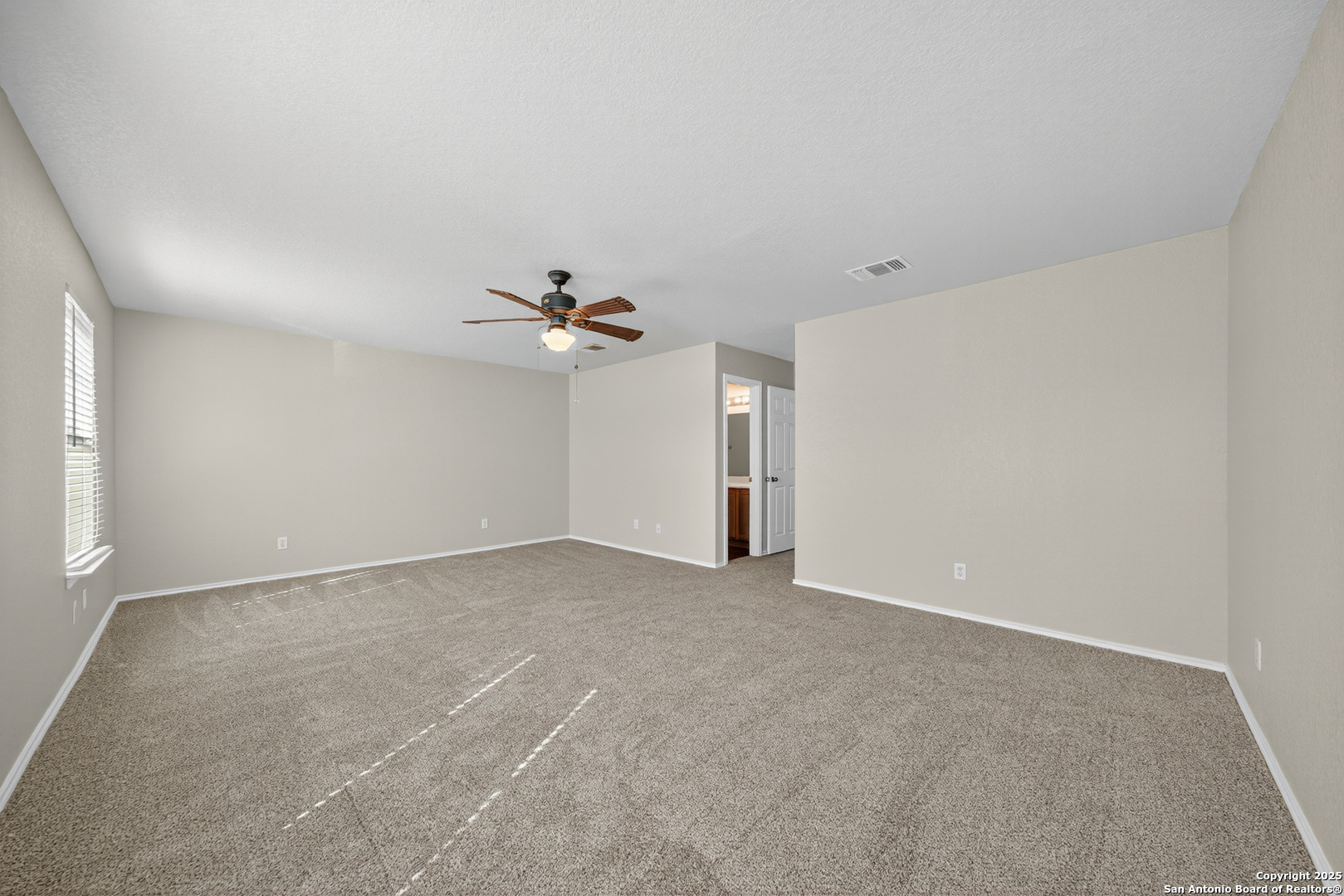 9619 Copper Spring Converse, TX 78109 - Photo 19 of 31 a view of an empty room with a ceiling fan