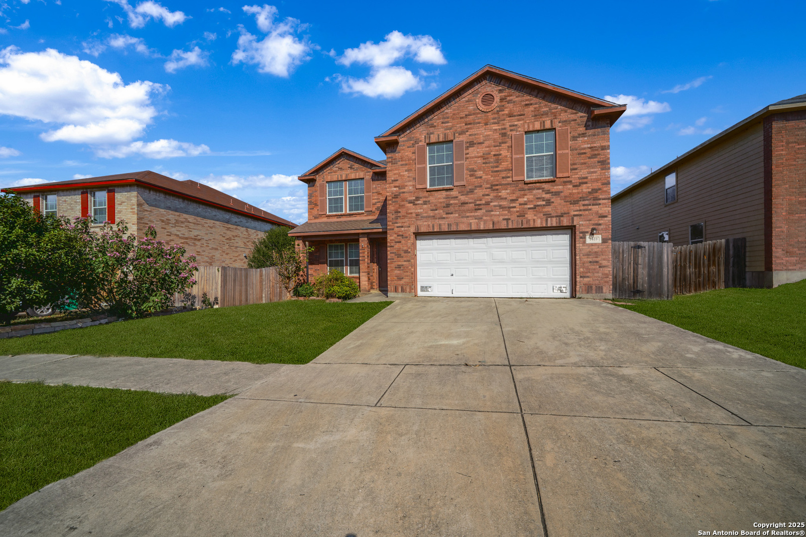9619 Copper Spring Converse, TX 78109 - Photo 2 of 31 a front view of a house with a yard and garage