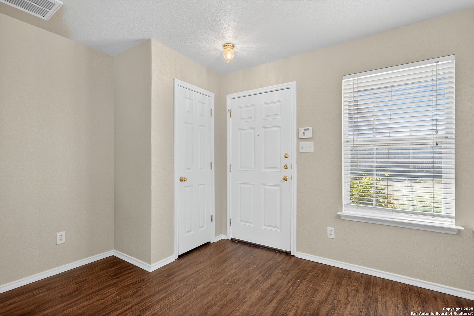 9619 Copper Spring Converse, TX 78109 - Photo 5 of 31 a view of an empty room with wooden floor and a window