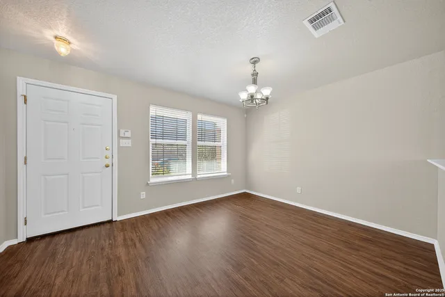 a view of wooden floor and windows in a room
