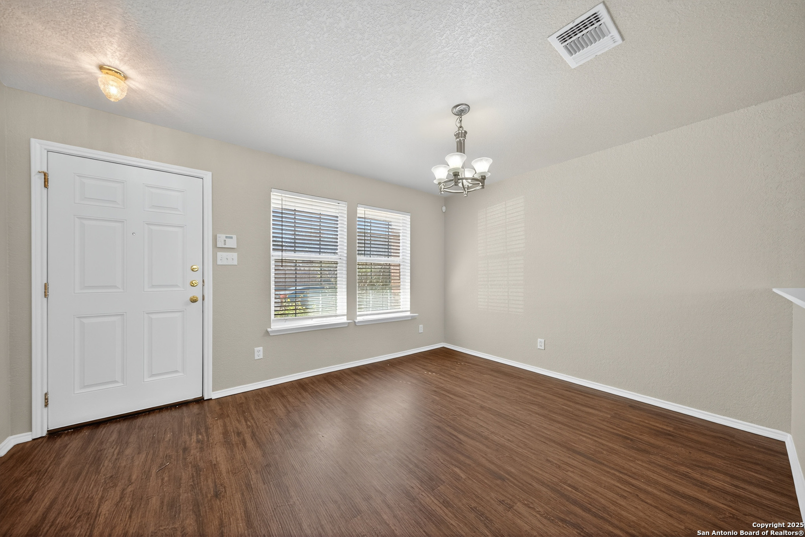 9619 Copper Spring Converse, TX 78109 - Photo 7 of 31 a view of wooden floor and windows in a room