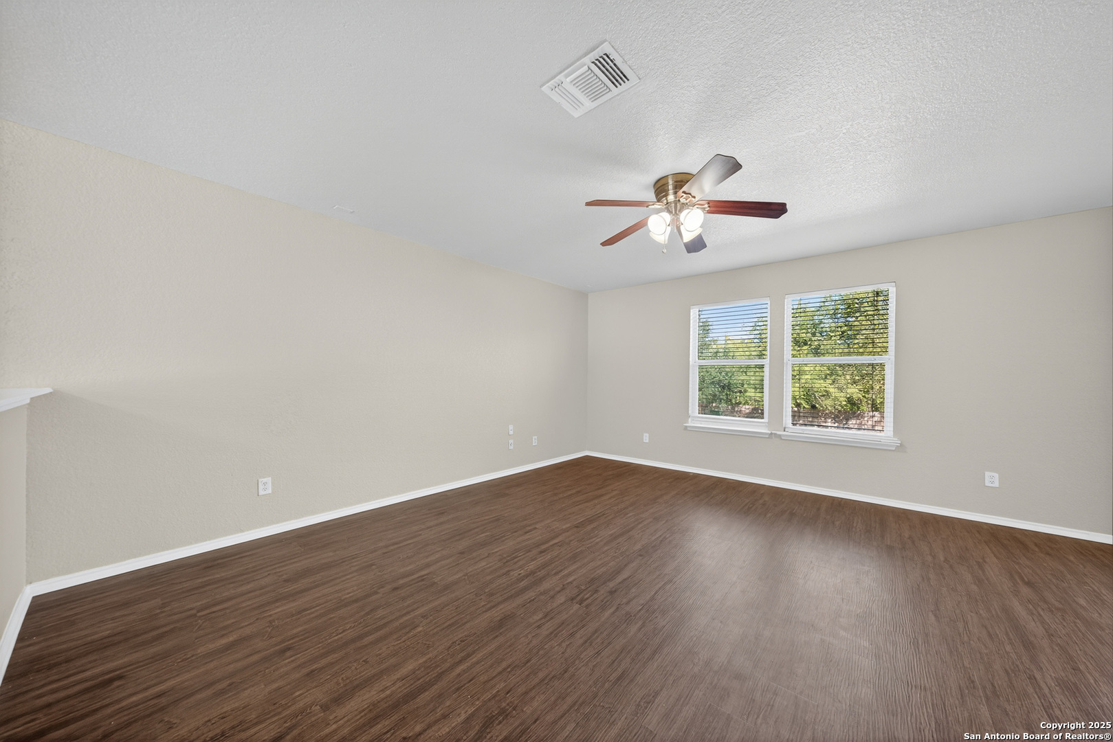 9619 Copper Spring Converse, TX 78109 - Photo 8 of 31 an empty room with wooden floor and ceiling fan