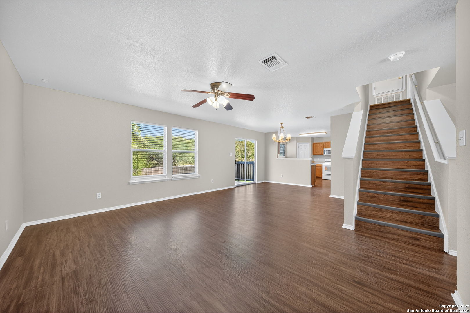9619 Copper Spring Converse, TX 78109 - Photo 9 of 31 an empty room with wooden floor and windows