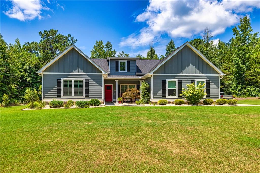 120 Courtland Road Brooks, GA 30205 - Photo 1 of 1 a front view of a house with swimming pool having outdoor seating