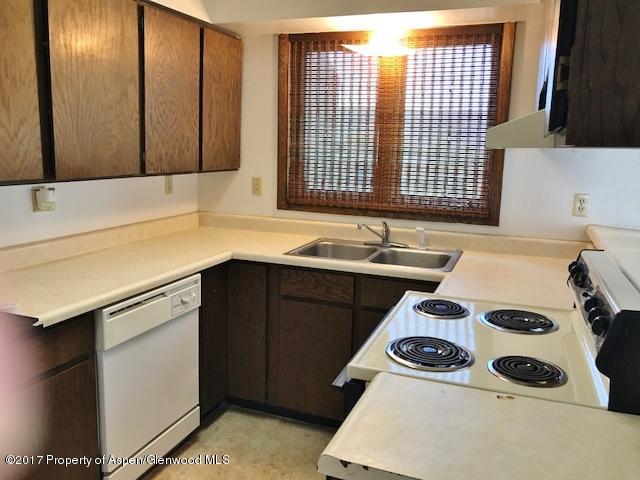 1151 Park Avenue Rifle, CO 81650 - Photo 4 of 9 a kitchen with a stove a sink and a microwave