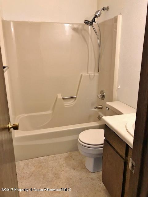 1151 Park Avenue Rifle, CO 81650 - Photo 7 of 9 a bathroom with a sink a toilet and shower
