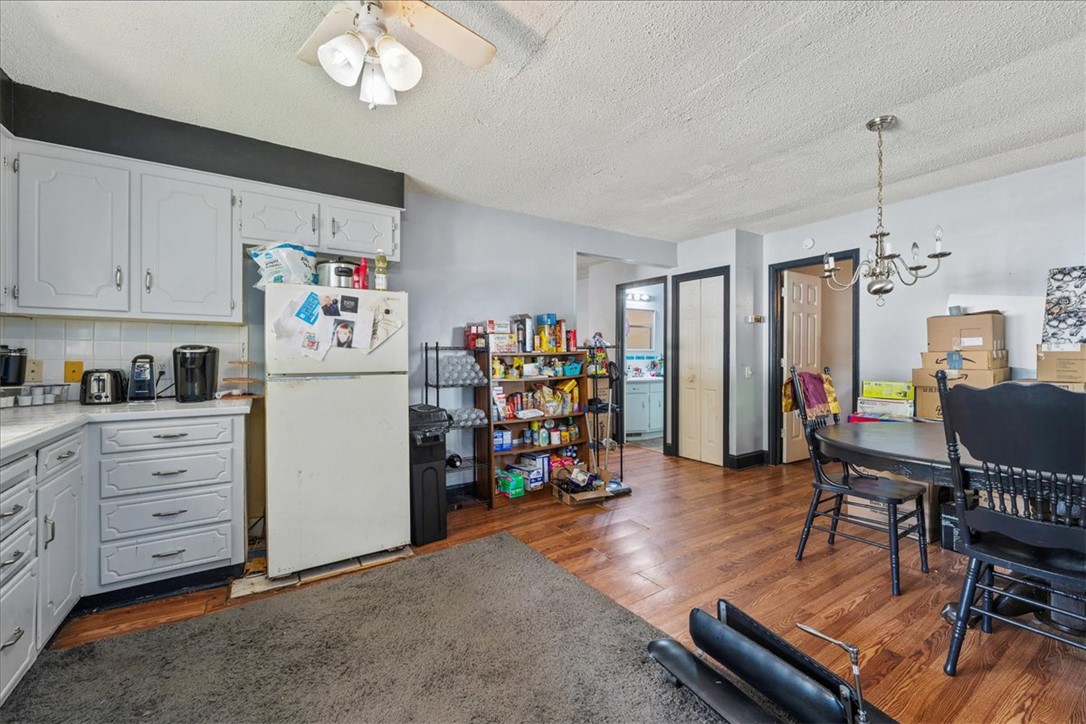 208 Holleman Street Seneca, SC 29678 - Photo 15 of 27 This kitchen and dining area features rich wood flooring, bright cabinetry, and ample storage space.