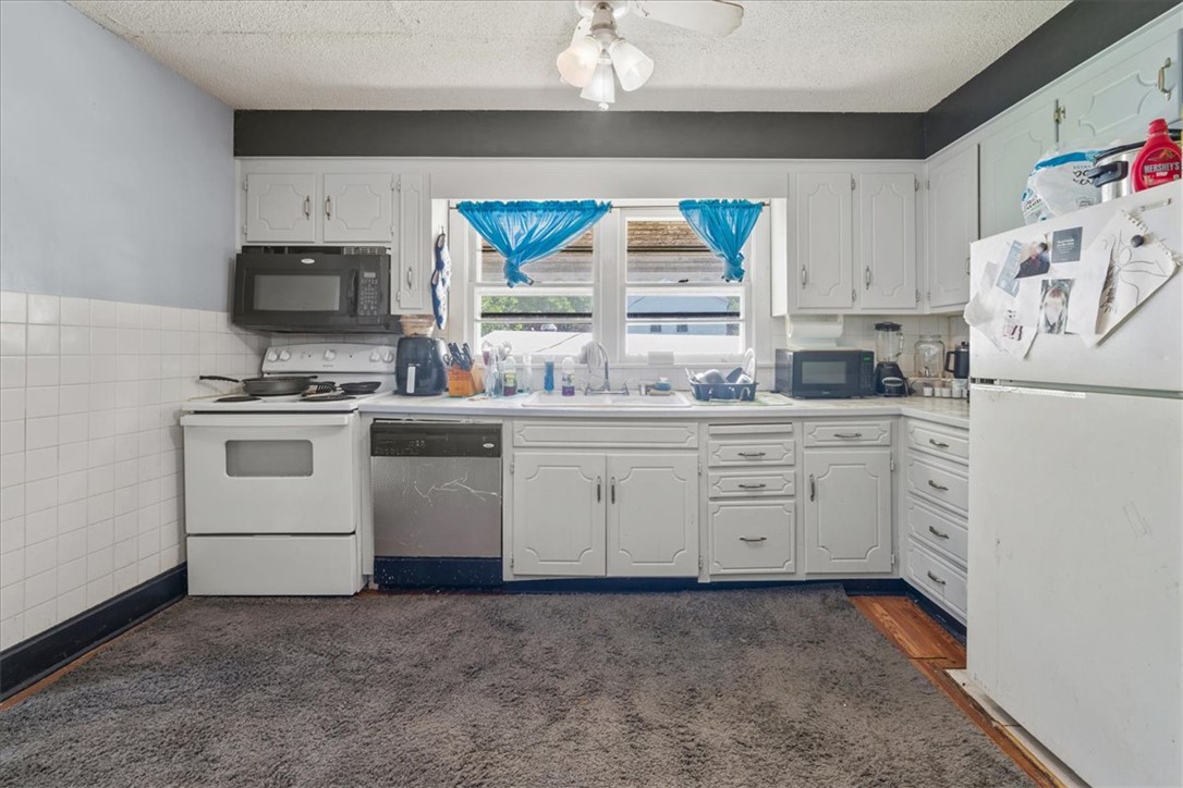 208 Holleman Street Seneca, SC 29678 - Photo 16 of 27 This bright kitchen features ample cabinetry and modern appliances, perfect for daily living.