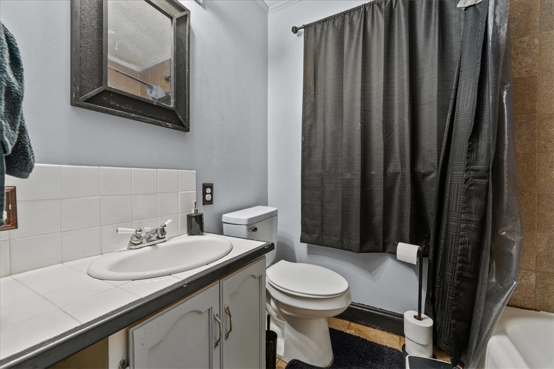 208 Holleman Street Seneca, SC 29678 - Photo 20 of 27 This bathroom features a classic tiled vanity and a clean, functional layout.