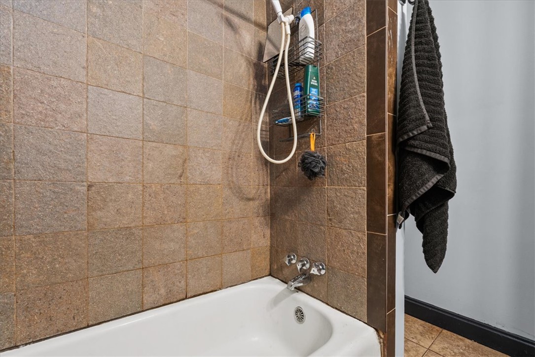 208 Holleman Street Seneca, SC 29678 - Photo 21 of 27 This bathroom features a classic bathtub with tiled walls, creating a clean and functional space.
