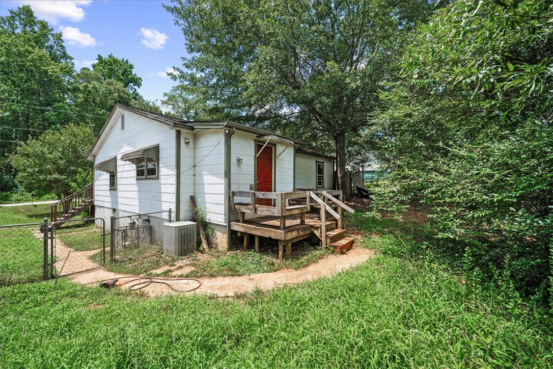 208 Holleman Street Seneca, SC 29678 - Photo 23 of 27 This charming home offers a welcoming exterior with a quaint wooden deck.