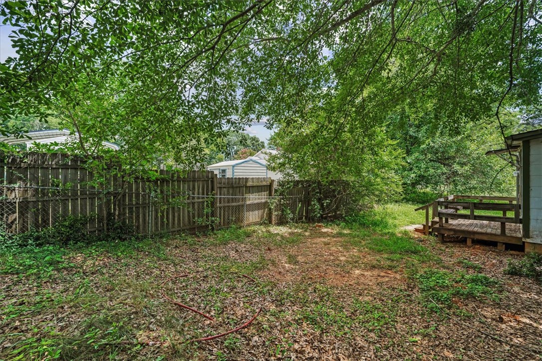 208 Holleman Street Seneca, SC 29678 - Photo 25 of 27 This spacious backyard with mature trees offers a serene private escape.