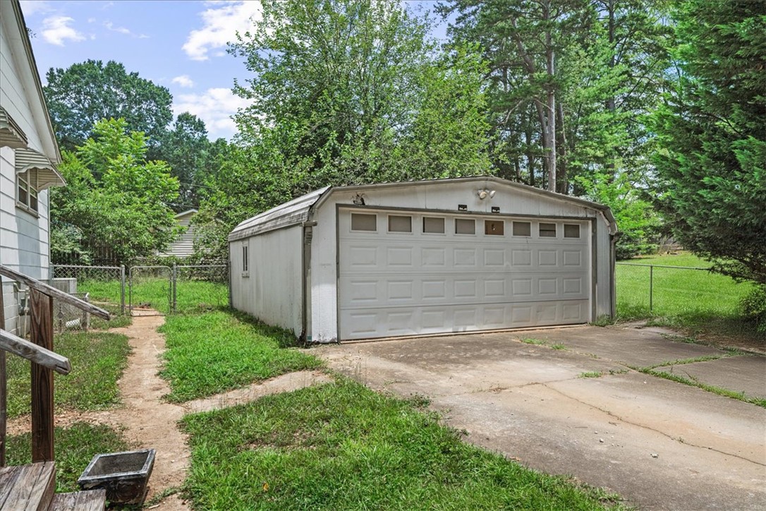 208 Holleman Street Seneca, SC 29678 - Photo 5 of 27 This property includes a detached garage and a spacious yard, offering both utility and outdoor potential.
