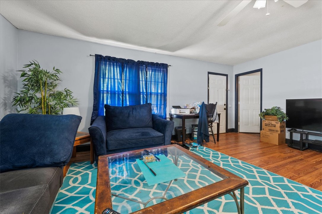 208 Holleman Street Seneca, SC 29678 - Photo 7 of 27 This inviting living space features warm wood floors and abundant natural light.