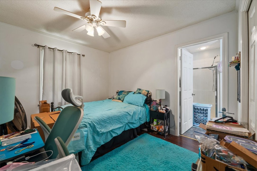 208 Holleman Street Seneca, SC 29678 - Photo 9 of 27 This cozy bedroom features rich hardwood flooring, a ceiling fan, and an adjacent private bathroom.