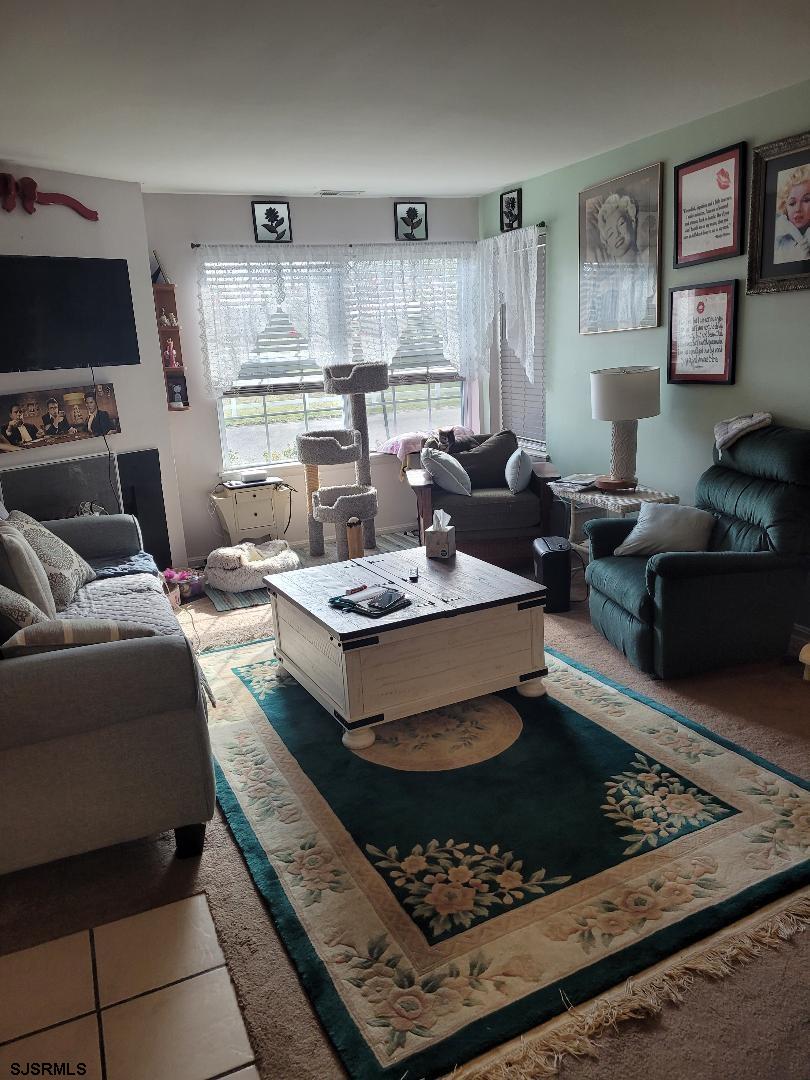 14 Meadow Ridge Road, Unit 14 Smithville, NJ 08205 - Photo 2 of 8 a living room with furniture and a wooden floor