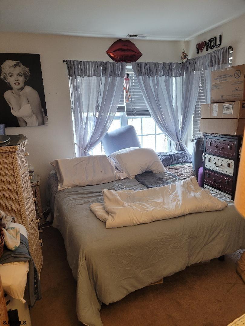 14 Meadow Ridge Road, Unit 14 Smithville, NJ 08205 - Photo 4 of 8 a bedroom with a bed and window