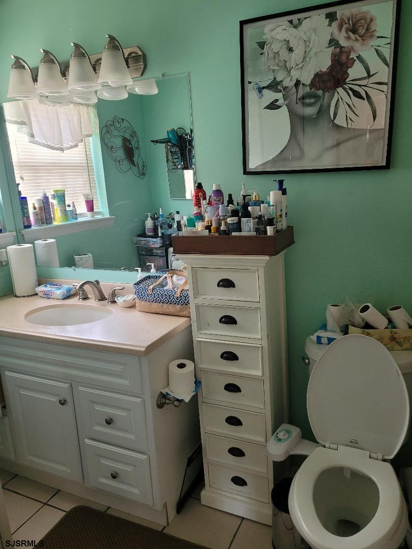 14 Meadow Ridge Road, Unit 14 Smithville, NJ 08205 - Photo 7 of 8 a bathroom with a sink mirror vanity and toilet