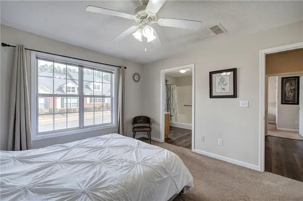 a bedroom with a large bed and a chandelier