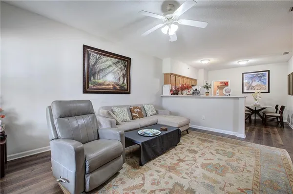 a living room with furniture and a dining area