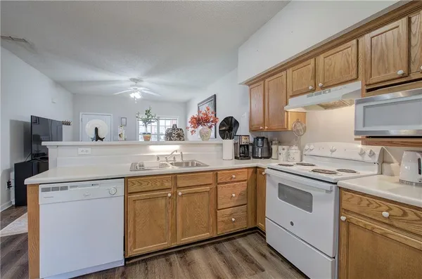 a kitchen with a sink stove and cabinets