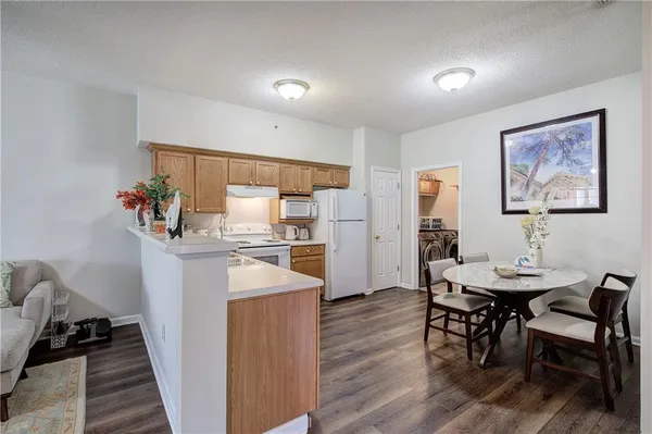 a dining room with furniture and wooden floor