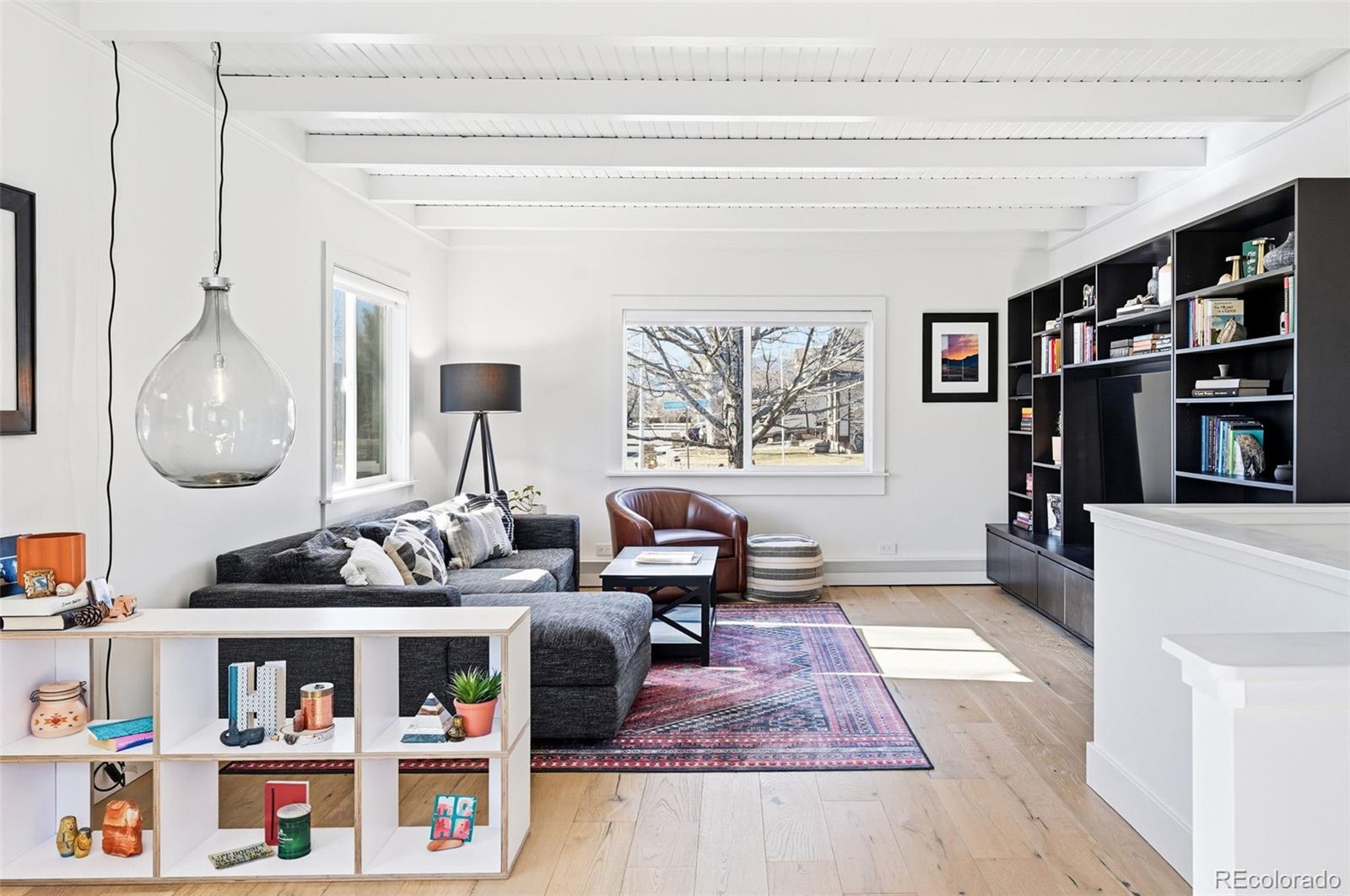 6940 Independence Street Arvada, CO 80004 - Photo 11 of 32 a living room with furniture and baby crib