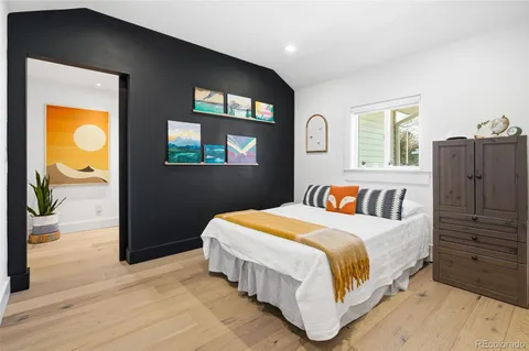 a bed room with a bed and a painting