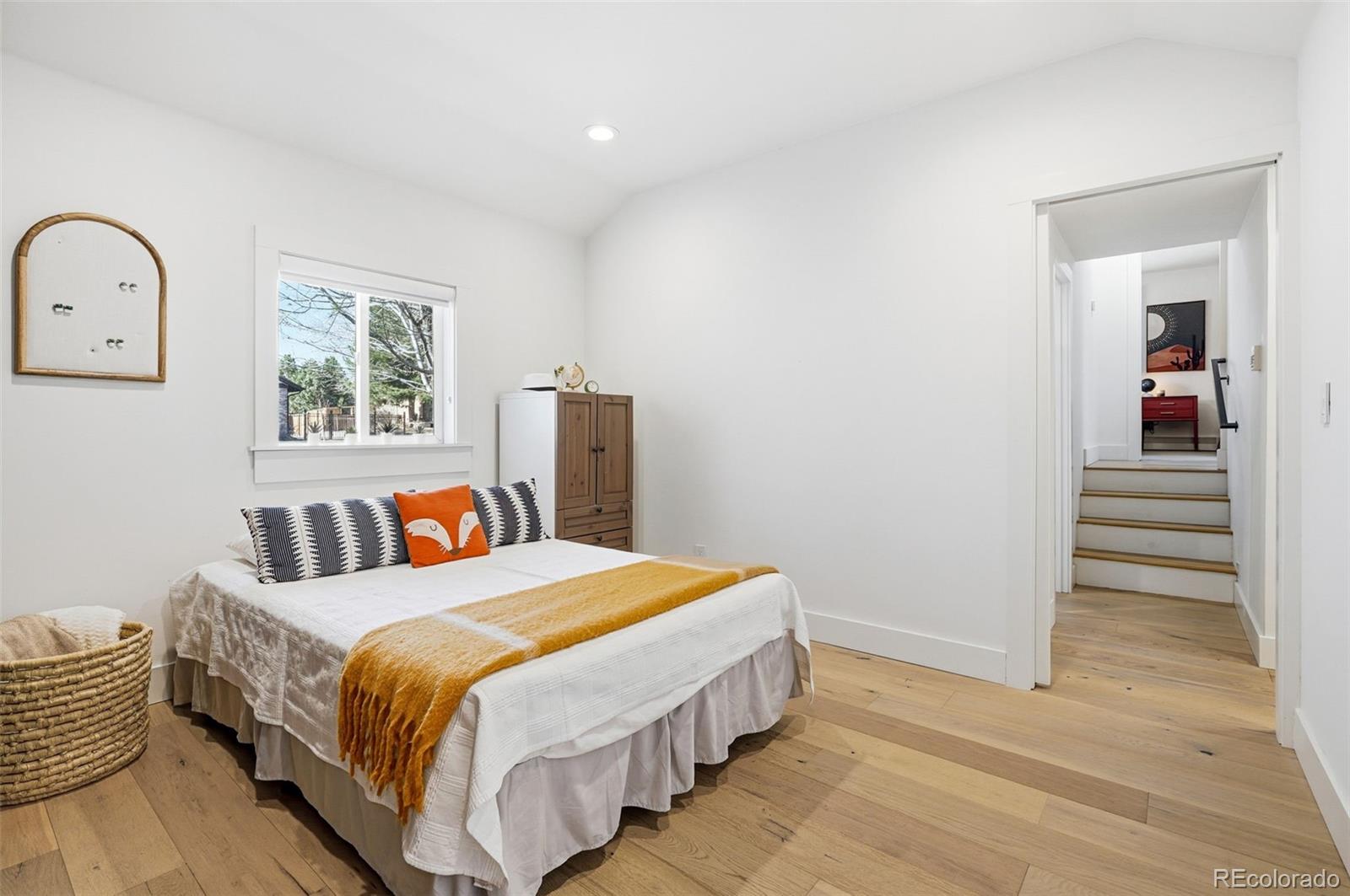 6940 Independence Street Arvada, CO 80004 - Photo 15 of 32 a bed room with a bed and a painting