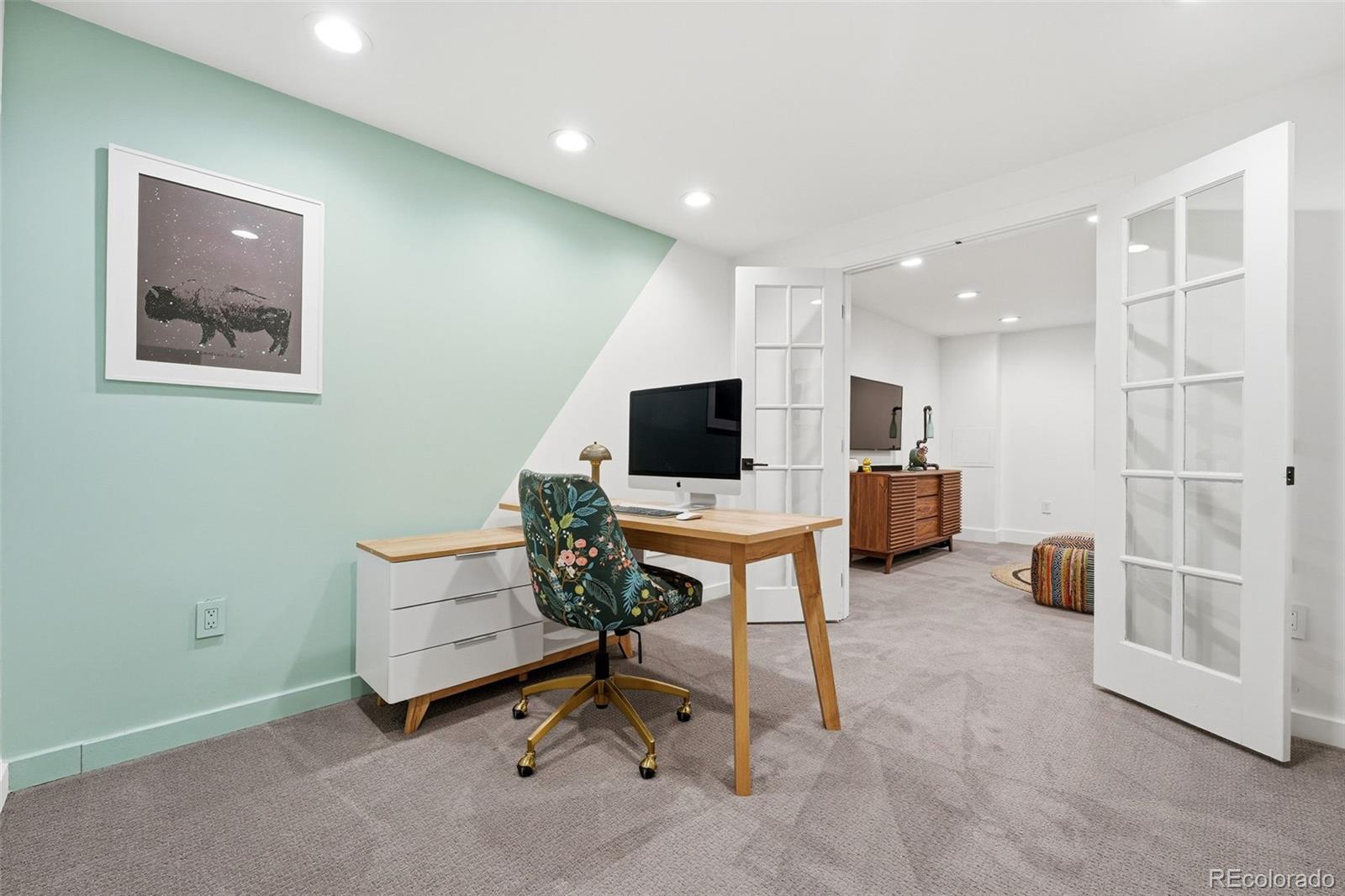 6940 Independence Street Arvada, CO 80004 - Photo 23 of 32 a living room with furniture and a flat screen tv