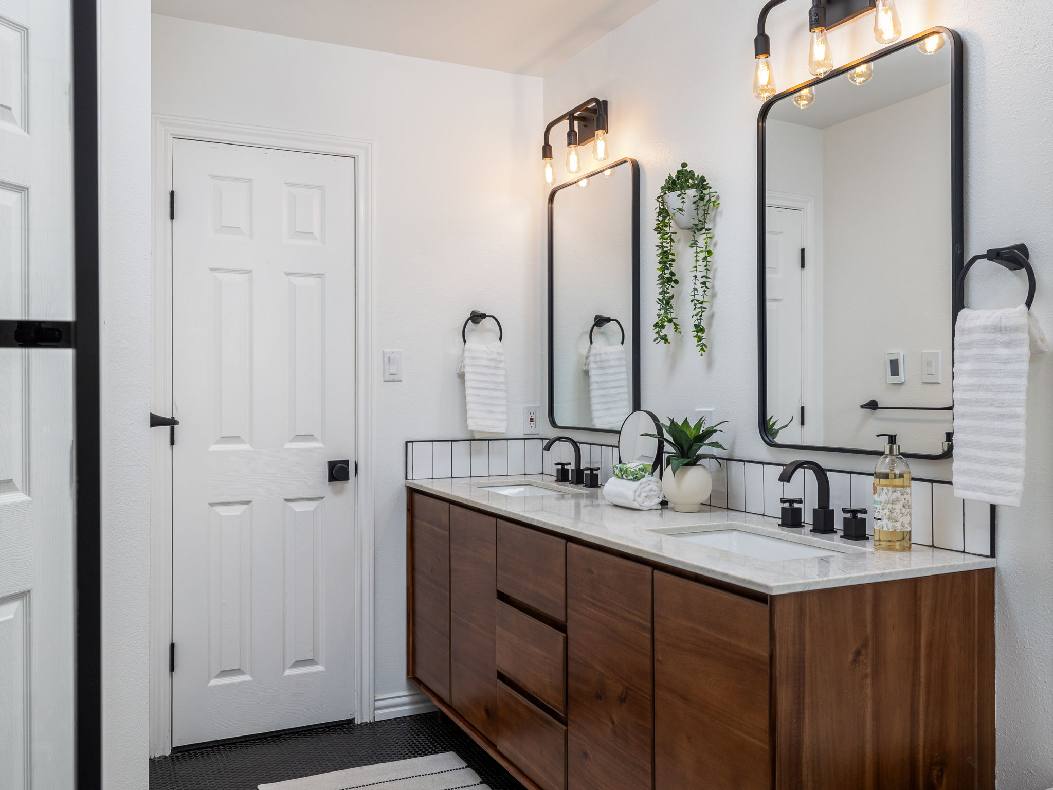 3001 County Road 255 Georgetown, TX 78633 - Photo 17 of 35 Double vanities with sleek black fixtures and framed mirrors create a chic, practical bathroom space.