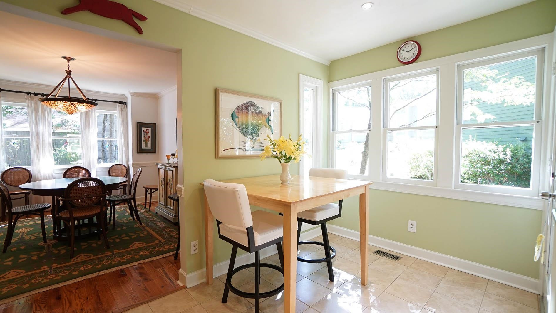 1809 Falls Church Road Raleigh, NC 27609 - Photo 11 of 56 a dining room with furniture a chandelier and wooden floor