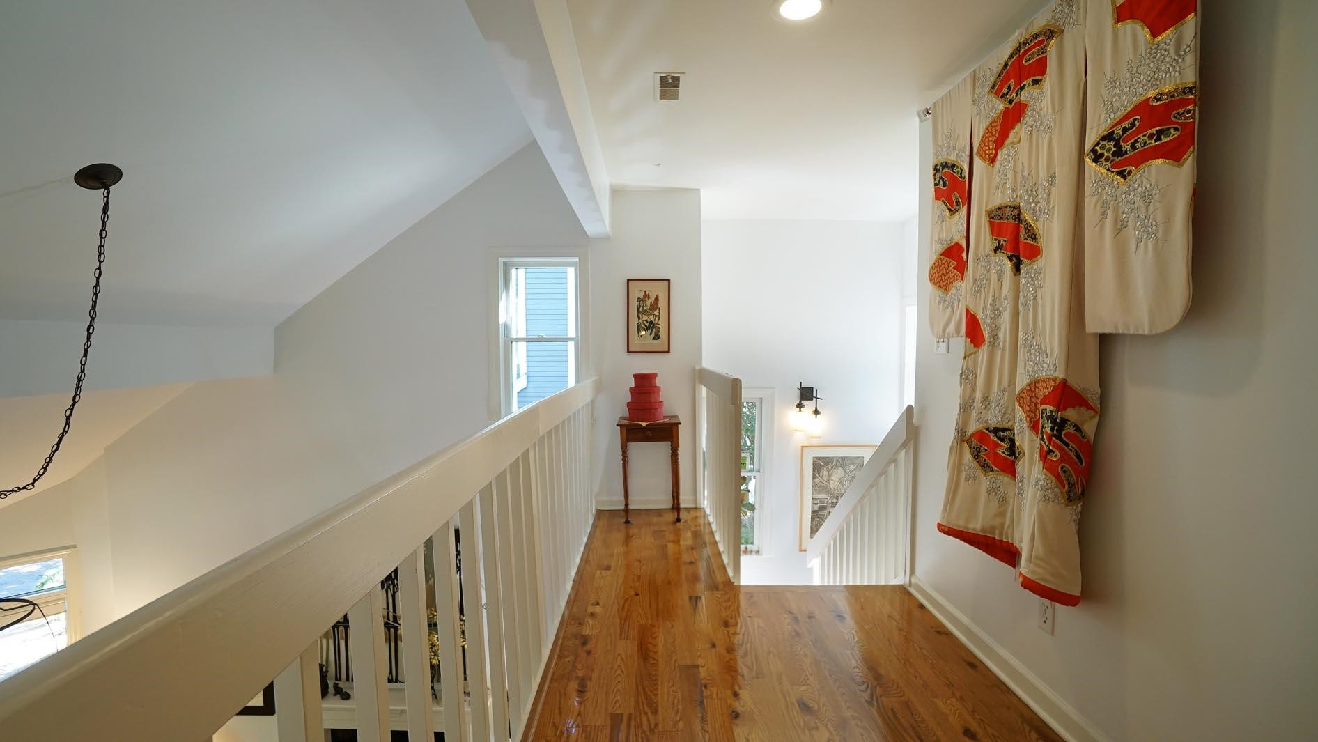 1809 Falls Church Road Raleigh, NC 27609 - Photo 35 of 56 a view of a hallway with wooden floor and windows