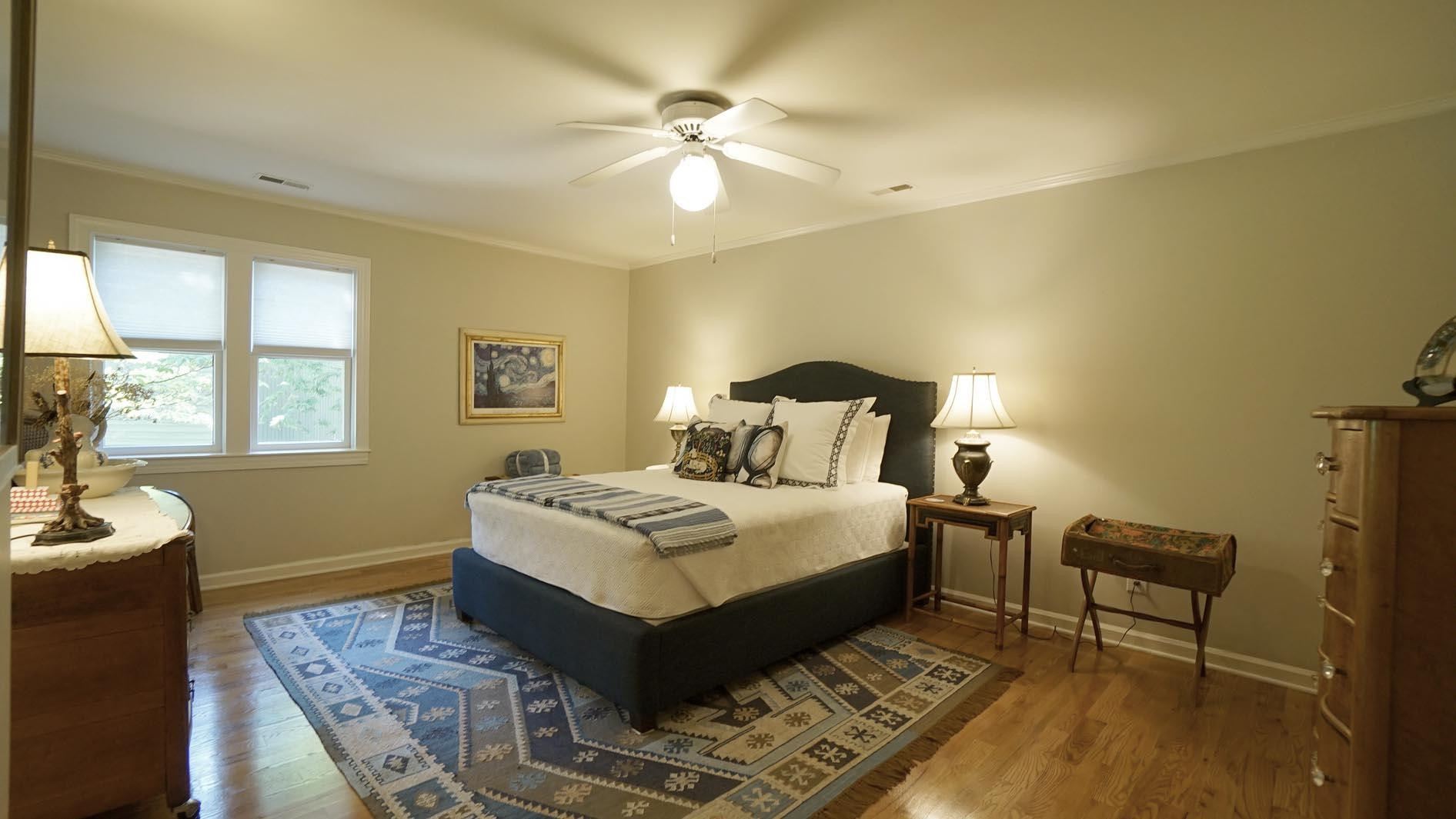 1809 Falls Church Road Raleigh, NC 27609 - Photo 40 of 56 a bedroom with a bed table and chair