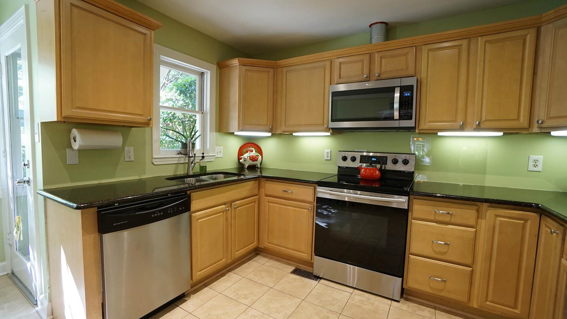 1809 Falls Church Road Raleigh, NC 27609 - Photo 4 of 56 a kitchen with stainless steel appliances granite countertop a sink and cabinets