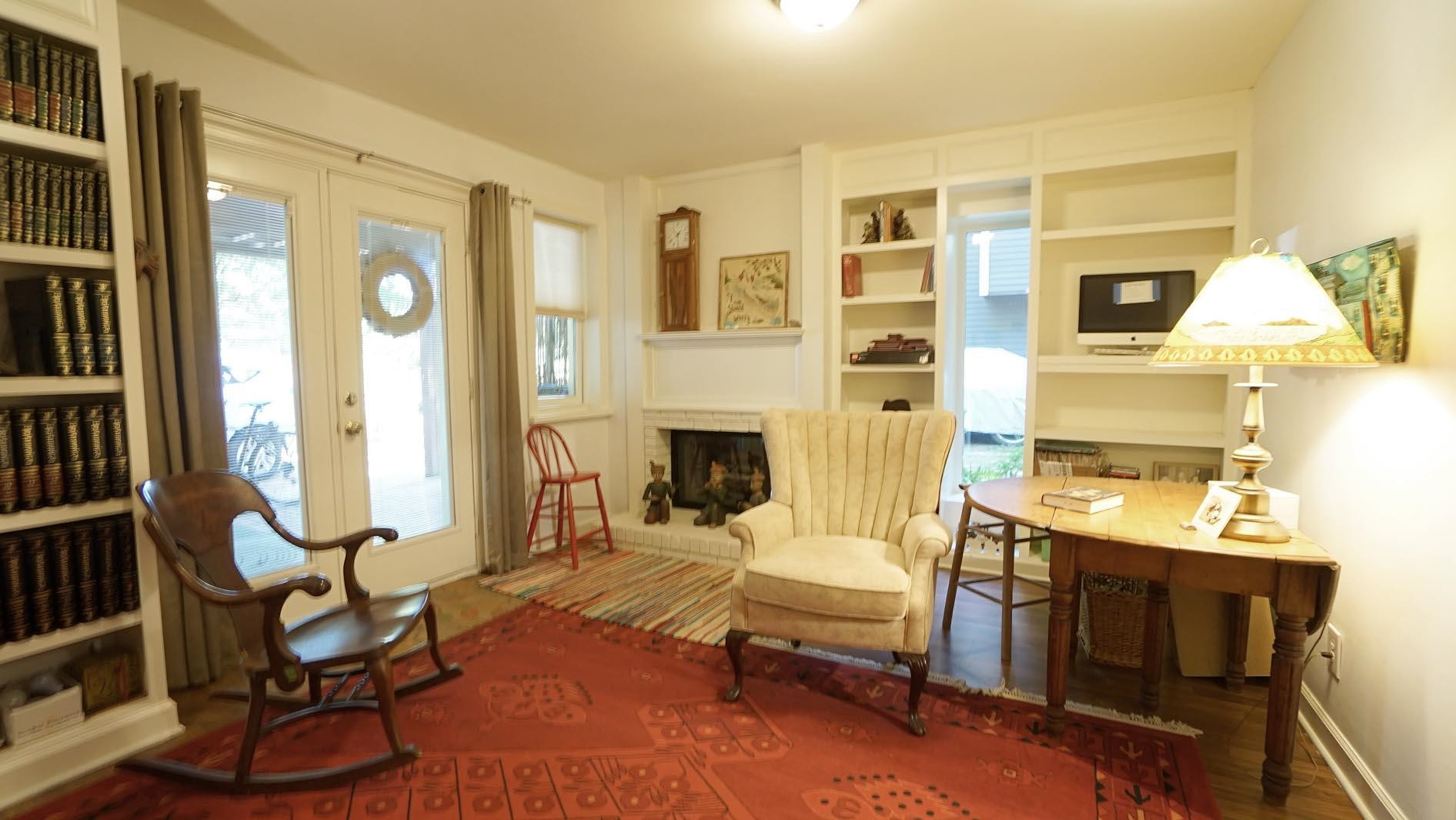 1809 Falls Church Road Raleigh, NC 27609 - Photo 44 of 56 a living room with furniture a fireplace and a large window