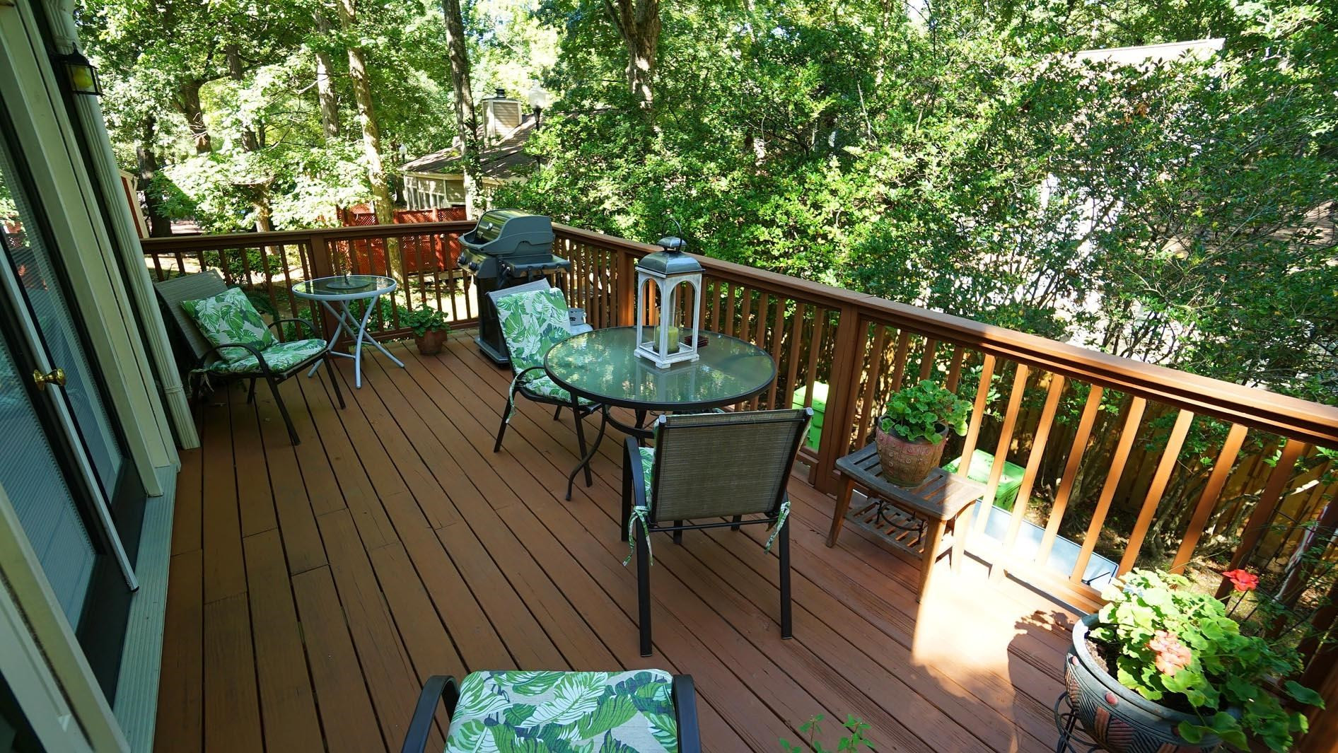 1809 Falls Church Road Raleigh, NC 27609 - Photo 49 of 56 a balcony with wooden floor outdoor seating and yard in back