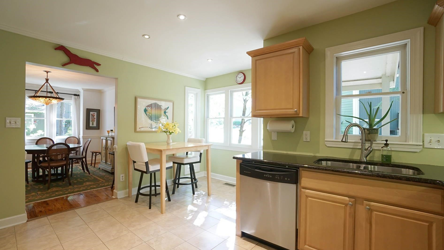 1809 Falls Church Road Raleigh, NC 27609 - Photo 10 of 56 a kitchen with lots of counter top space and dining table
