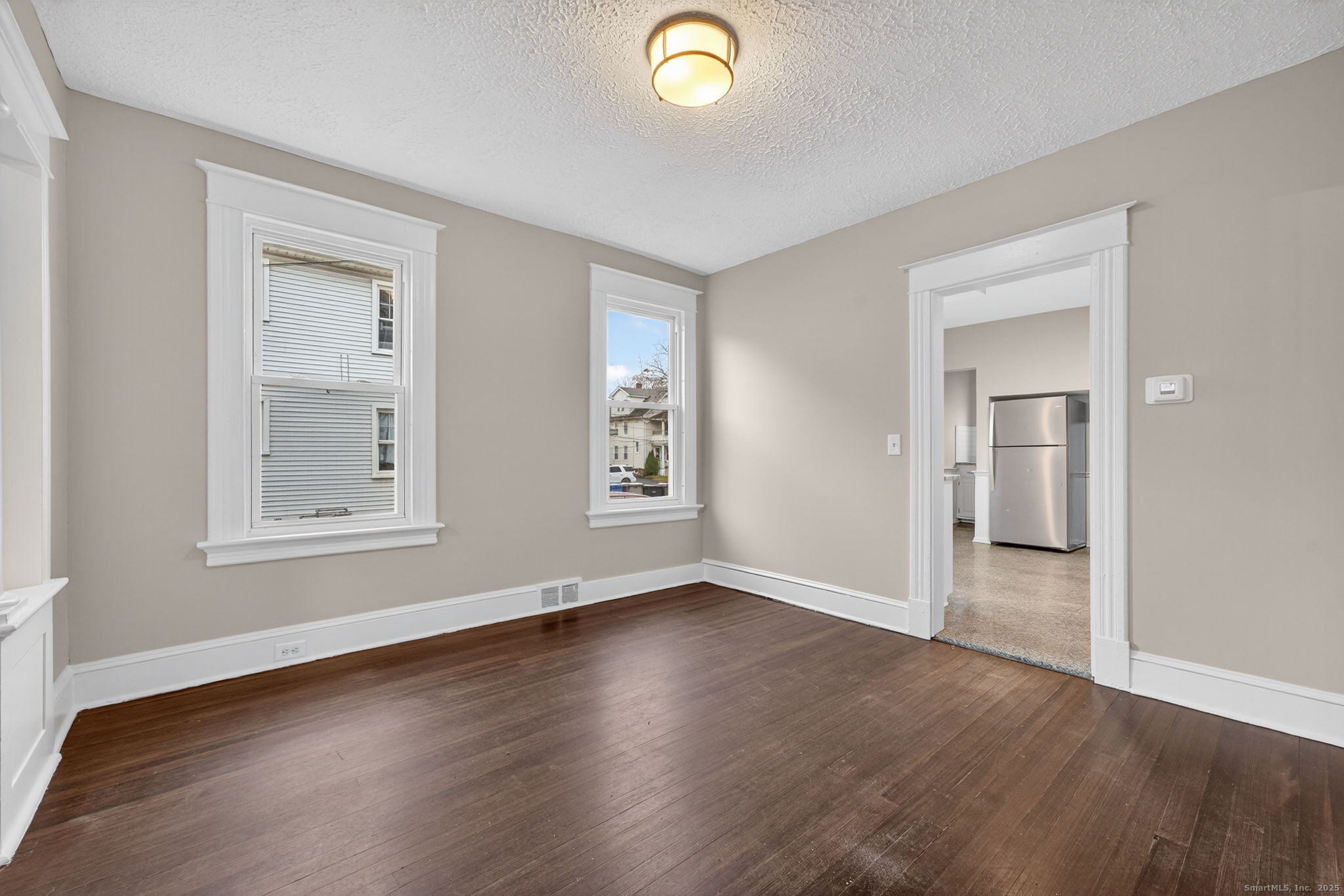 38 Center Street Bristol, CT 06010 - Photo 12 of 28 an empty room with wooden floor and windows
