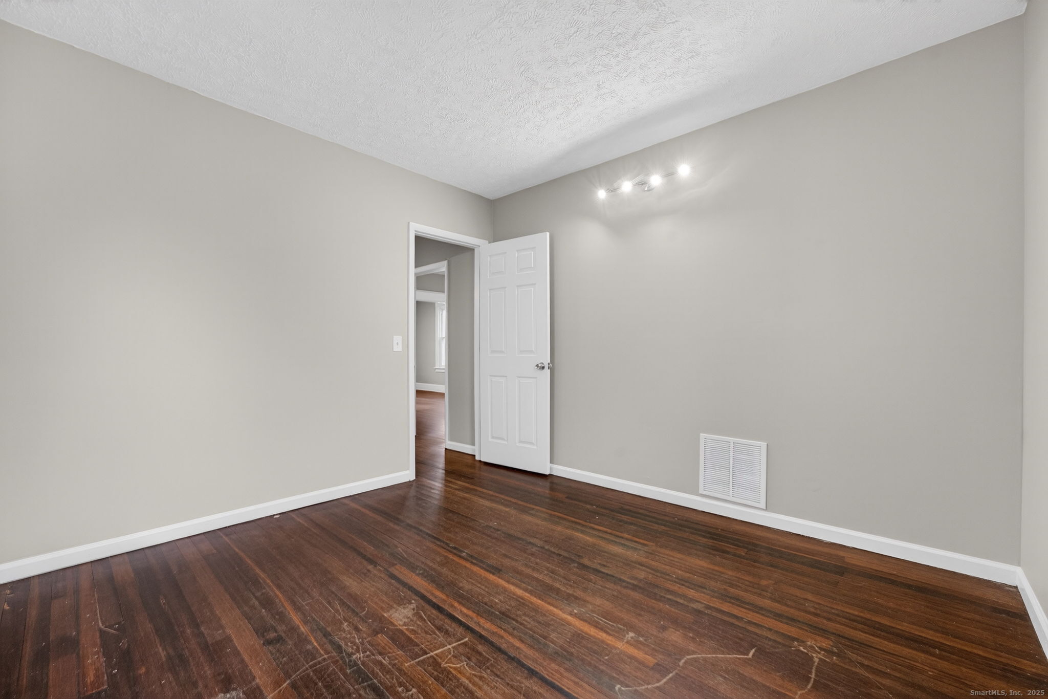 38 Center Street Bristol, CT 06010 - Photo 14 of 28 a view of an empty room with wooden floor