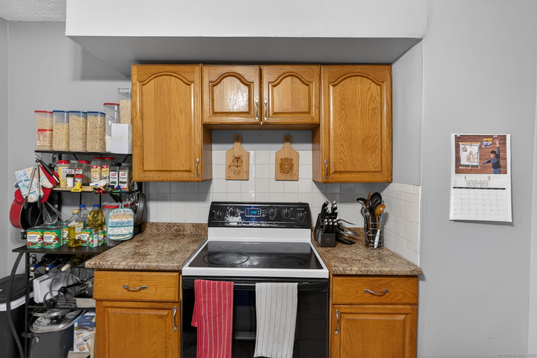 38 Center Street Bristol, CT 06010 - Photo 19 of 28 a kitchen with a stove a sink and a refrigerator