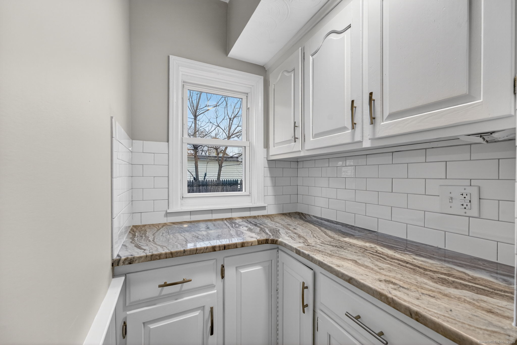 38 Center Street Bristol, CT 06010 - Photo 5 of 28 a kitchen with granite countertop white cabinets and a sink