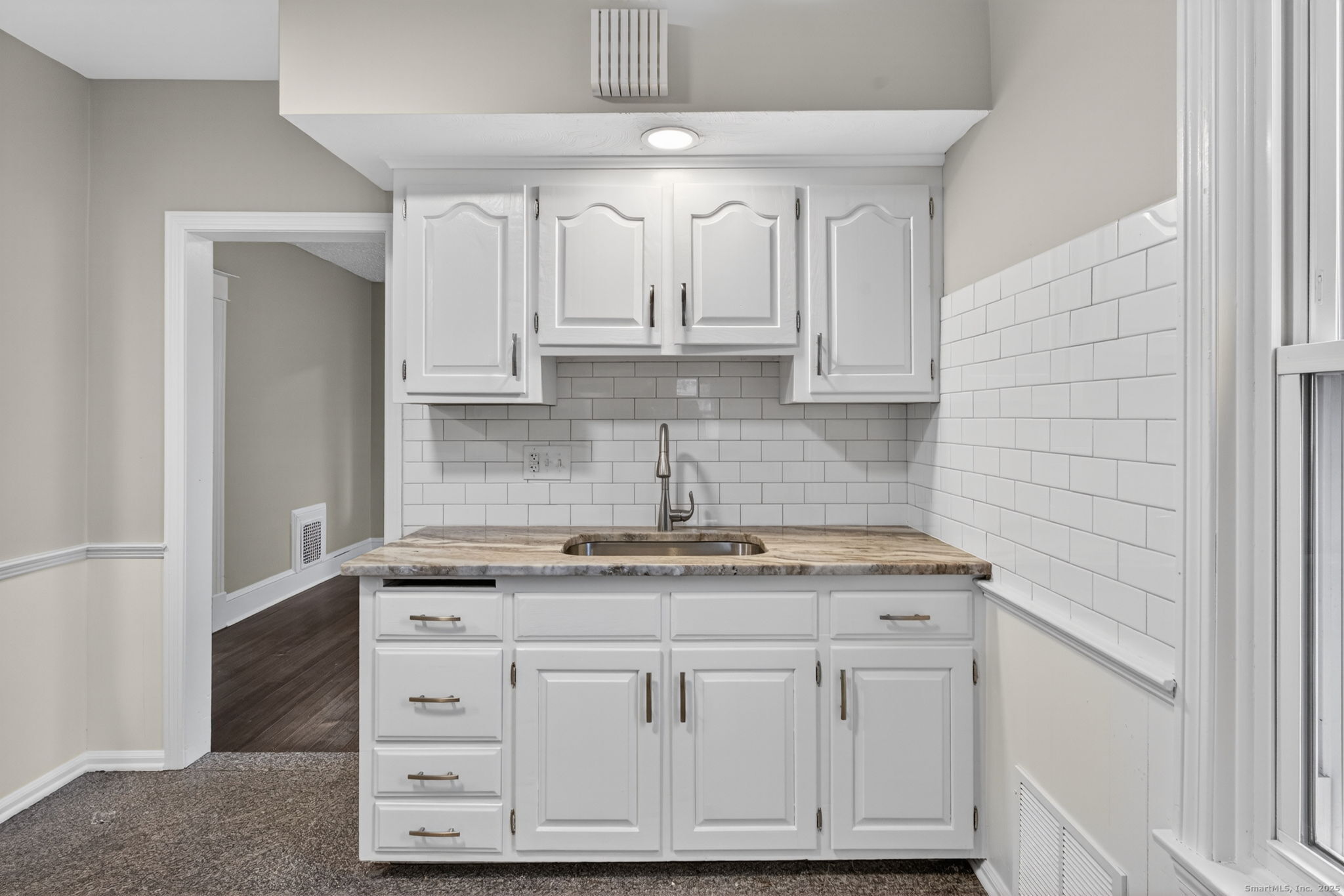 38 Center Street Bristol, CT 06010 - Photo 6 of 28 a kitchen with cabinets appliances a sink and a counter top space