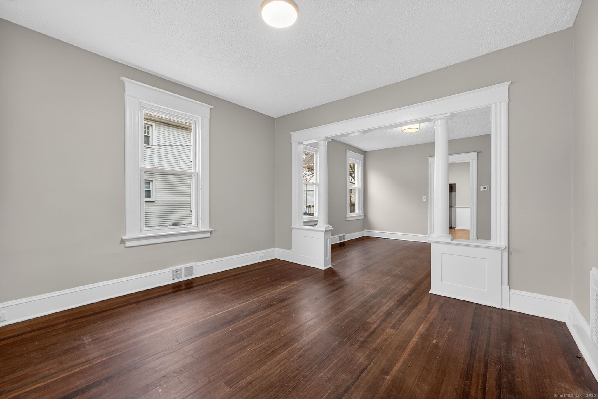38 Center Street Bristol, CT 06010 - Photo 7 of 28 an empty room with wooden floor and windows
