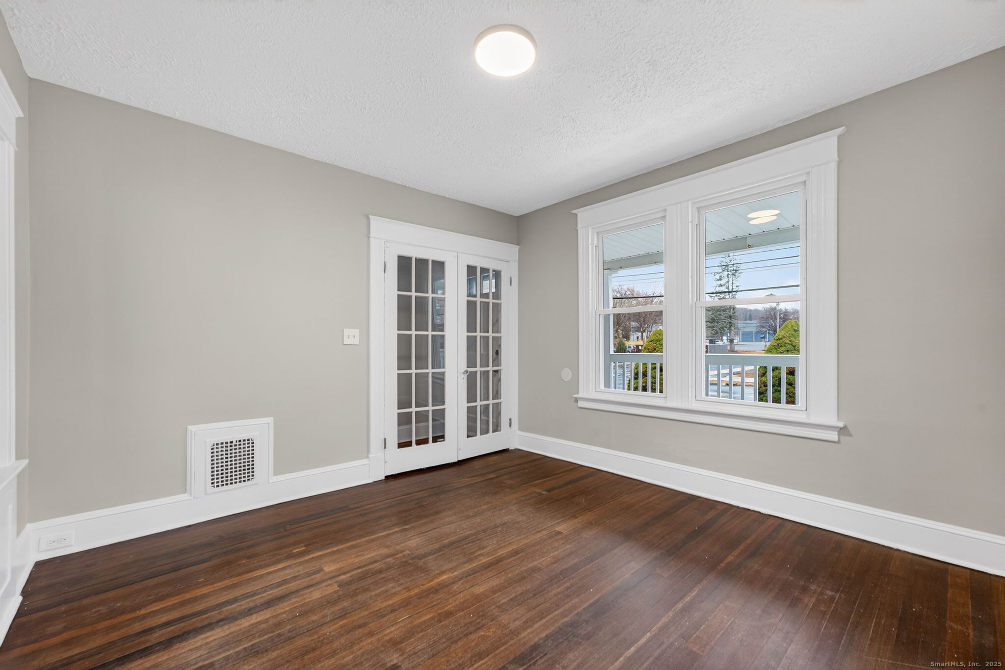 38 Center Street Bristol, CT 06010 - Photo 9 of 28 a view of an empty room with wooden floor and a window