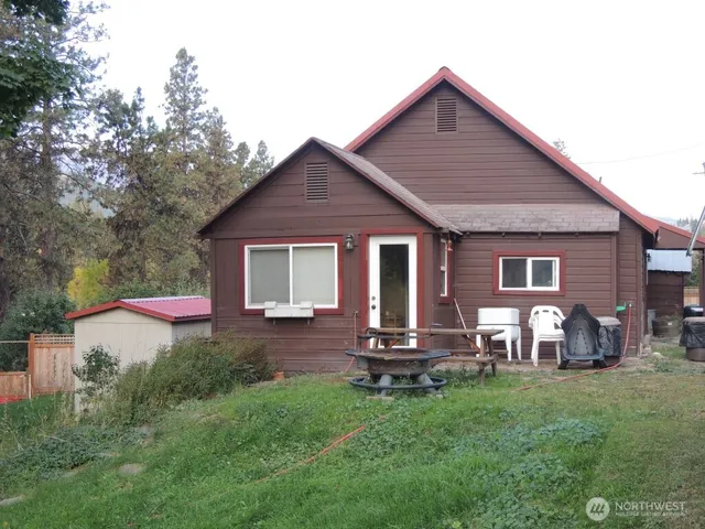 a front view of house with yard and outdoor seating