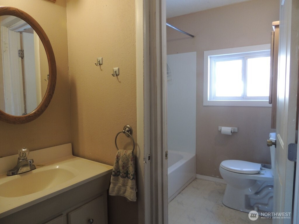 9291 Pakascwa Road Peshastin, WA 98847 - Photo 24 of 38 a bathroom with a sink a toilet and a mirror