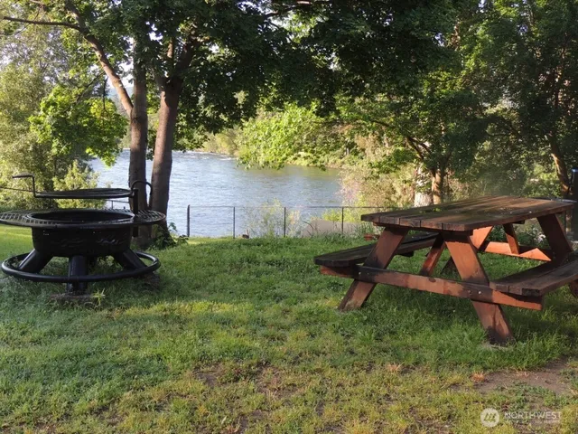 a view of a field of grass and trees