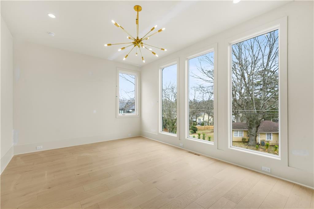3214 Osborne Road Northeast Atlanta, GA 30319 - Photo 36 of 41 an empty room with windows and chandelier fan