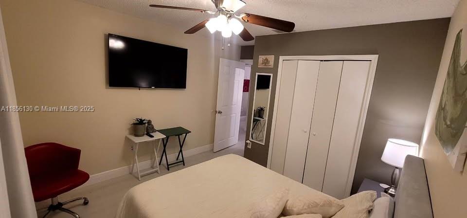 14447 Southwest 152nd Terrace, Unit BACKDOOR Miami, FL 33177 - Photo 2 of 10 a bedroom with a bed and a flat screen tv